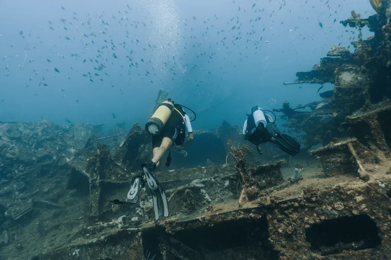 Snorkelers above the coral-covered Antilla shipwreck off the northwest coast of Aruba