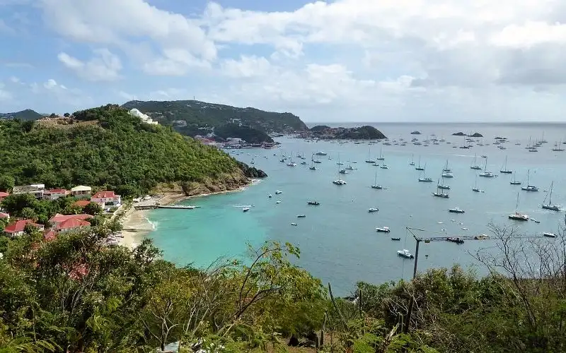 Small fishing boats pulled up on the beach in the traditional village of Corossol, Saint Barthelemy