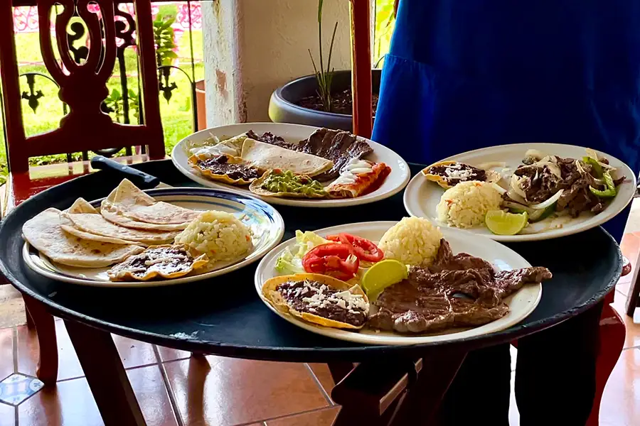 Plate of tacos al pastor with salsa and lime at a local taqueria in Cozumel