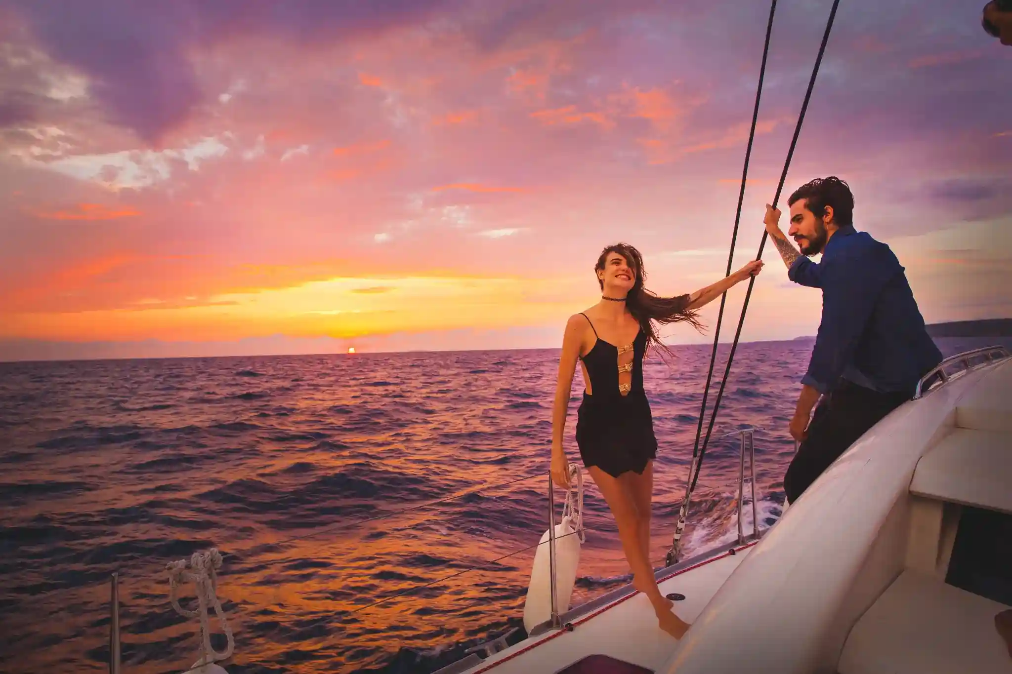 Catamaran sailing off Cozumel's west coast at sunset