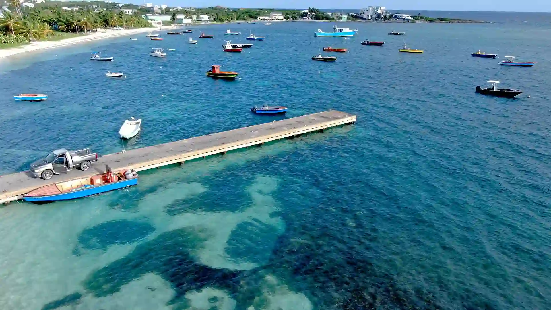 Colorful wooden fishing boats moored in the bay at Island Harbour, Anguilla