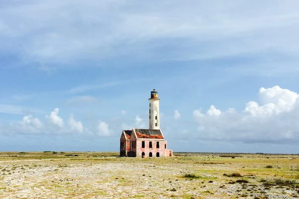 The pink abandoned lighthouse and white sand beach on Klein Curacao