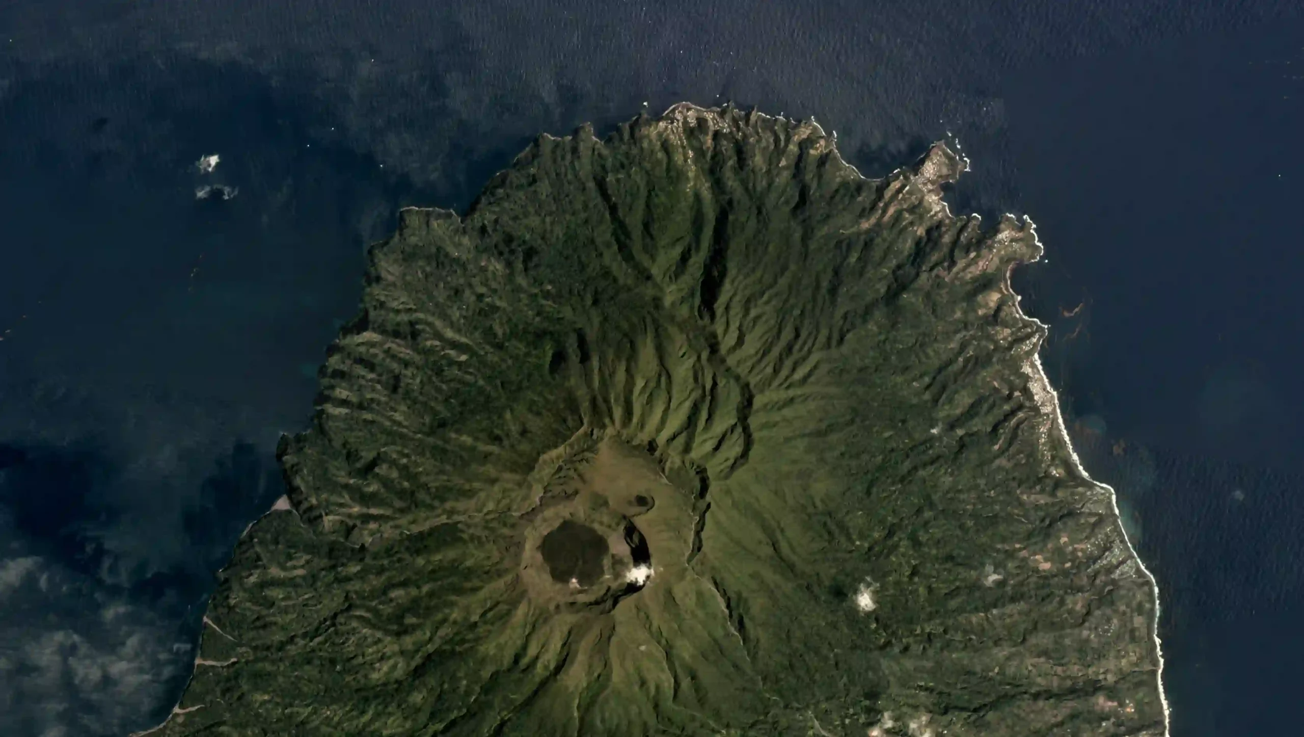 View into the crater of La Soufrière volcano on Saint Vincent with clouds drifting over the rim