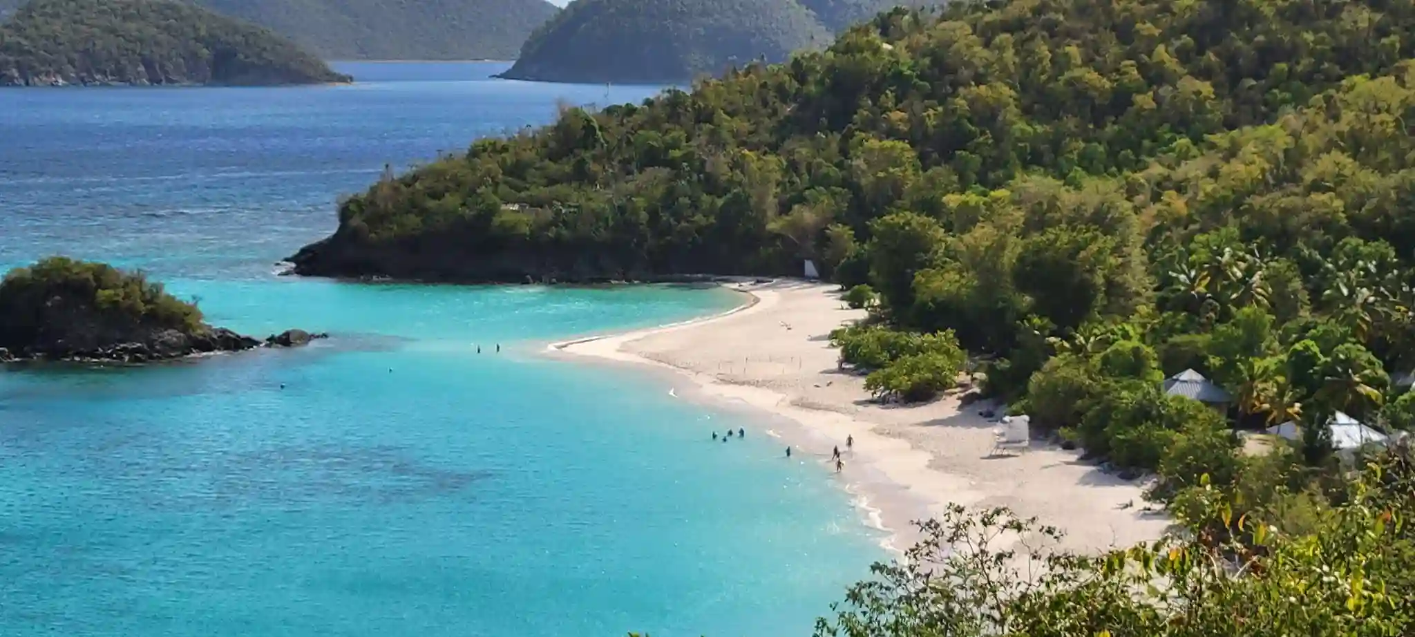 Heart-shaped Magens Bay seen from Drake's Seat, with calm turquoise water and green hills, St. Thomas
