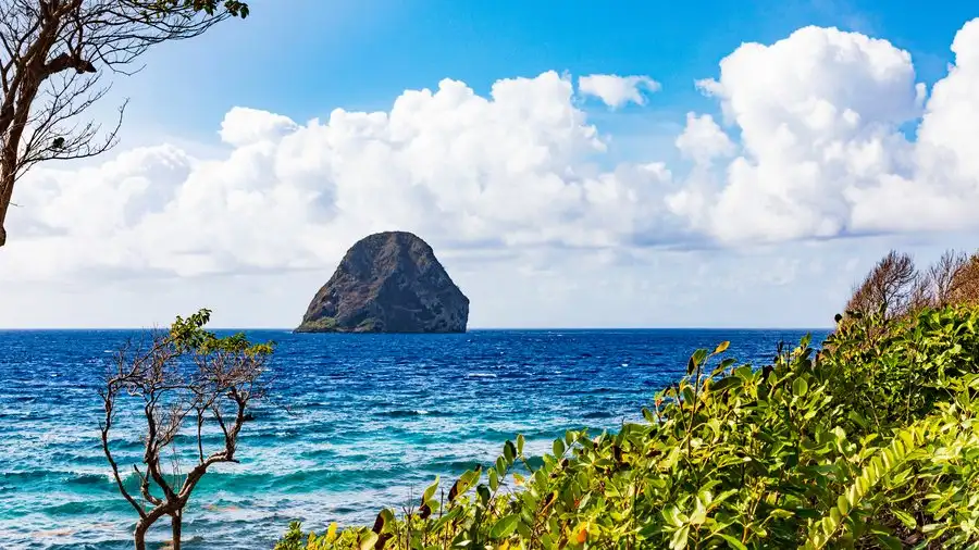 Martinique's southern coastline with green hills, turquoise water and Diamond Rock offshore