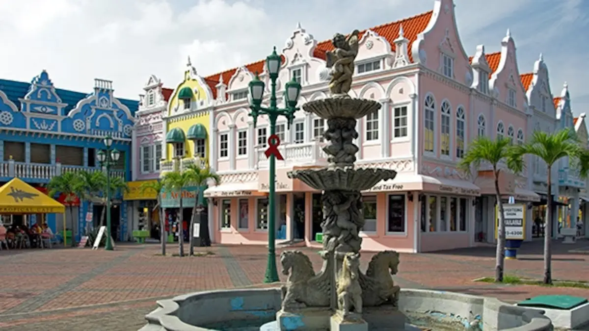 Pastel Dutch colonial buildings and the streetcar on Main Street in Oranjestad, Aruba