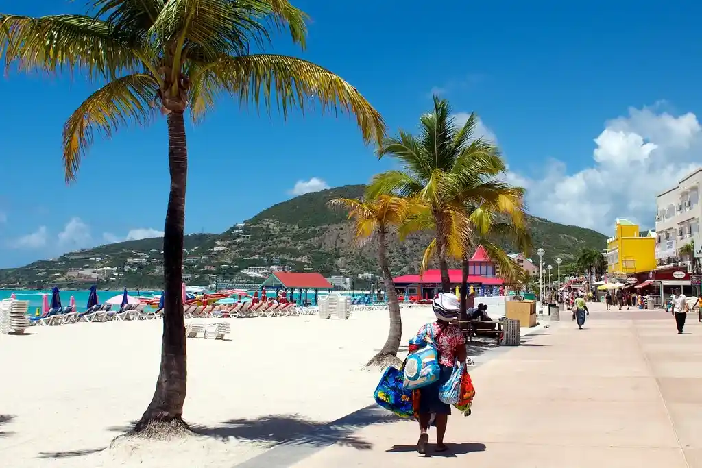 Beachfront boardwalk along Great Bay in Philipsburg, Sint Maarten, with shops and palm trees