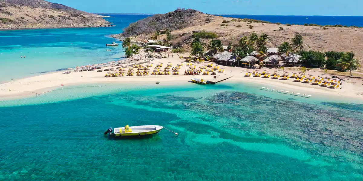 Calm shallow turquoise water and white sand beach on Pinel Island off Saint Martin