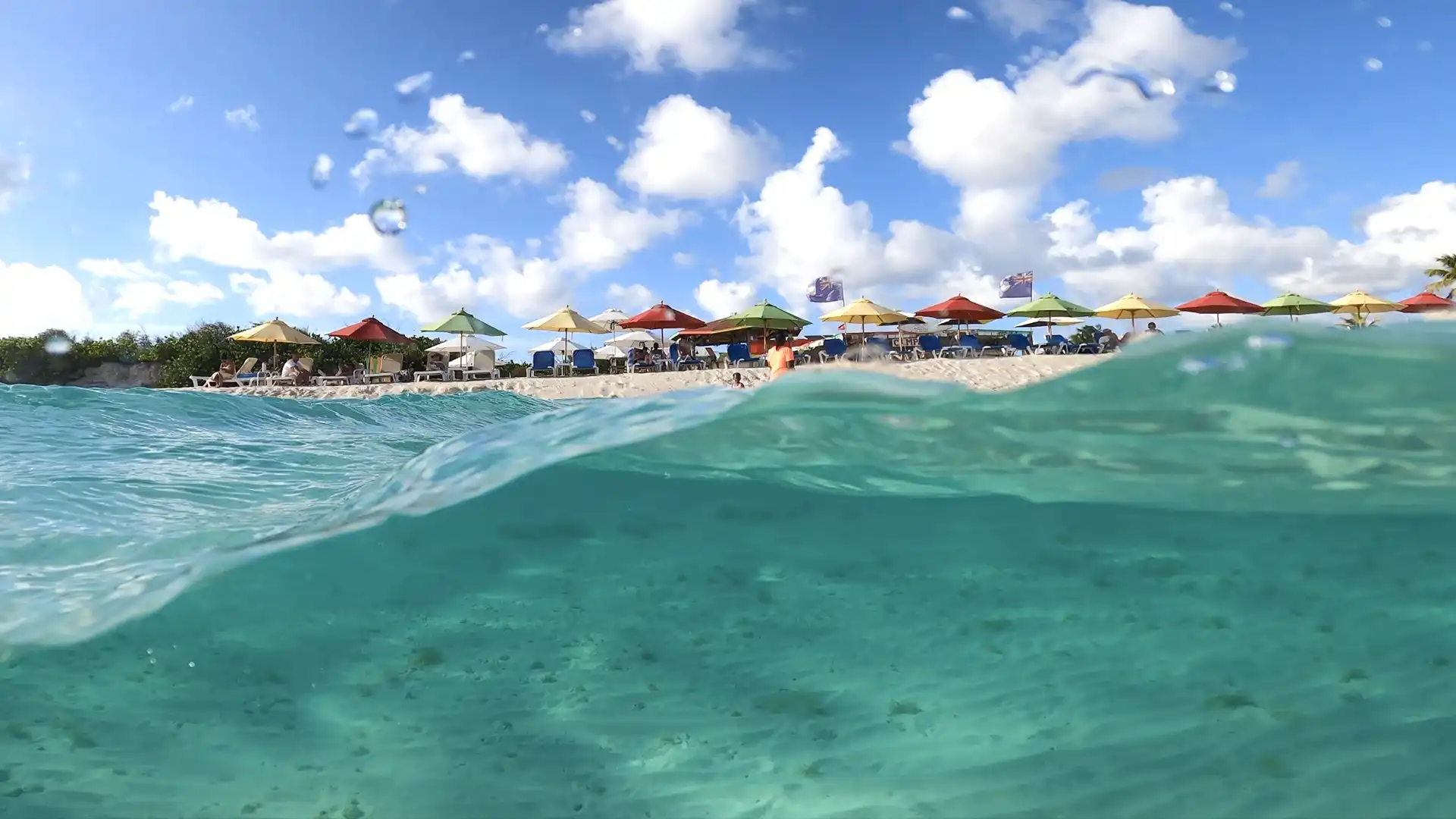 Long empty stretch of Rendezvous Bay beach in Anguilla with Saint Martin's hills on the horizon