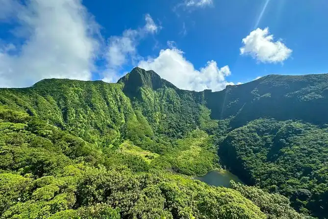 View into the forested volcanic crater of Mount Liamuiga, Saint Kitts, with clouds drifting over the rim