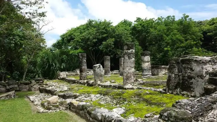 Ancient Mayan stone structure surrounded by jungle at San Gervasio archaeological site, Cozumel