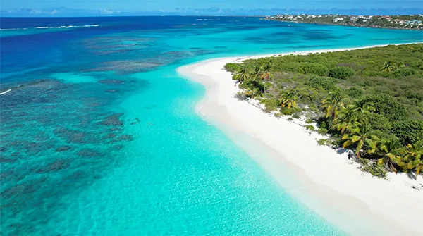 Soft white sand and clear turquoise water at Shoal Bay East beach in Anguilla