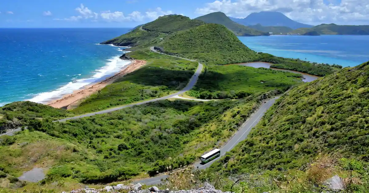 Aerial view of the South East Peninsula of Saint Kitts with green hills, salt ponds and Nevis across the channel