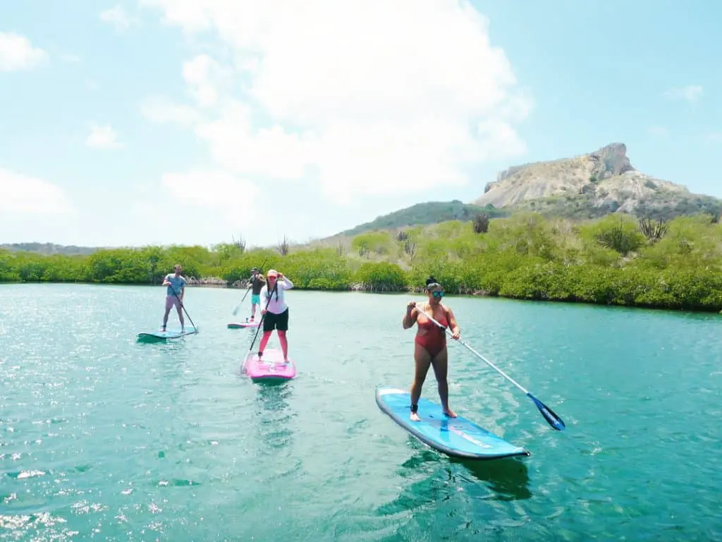 Stand-up paddleboarder on the calm water of Spanish Water lagoon in Curacao