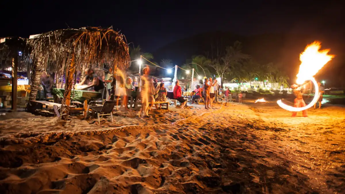 Colorful beach bars with lights at dusk along the Strip on South Frigate Bay, Saint Kitts