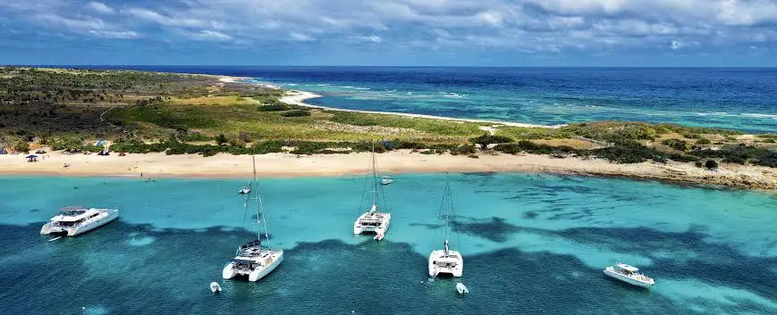 Deserted white sand beach and clear water on uninhabited Tintamarre Island near Saint Martin