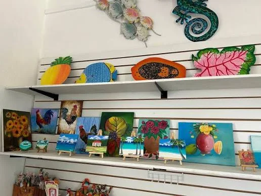Caribbean paintings and handmade sculpture on display in a small Anguilla art gallery